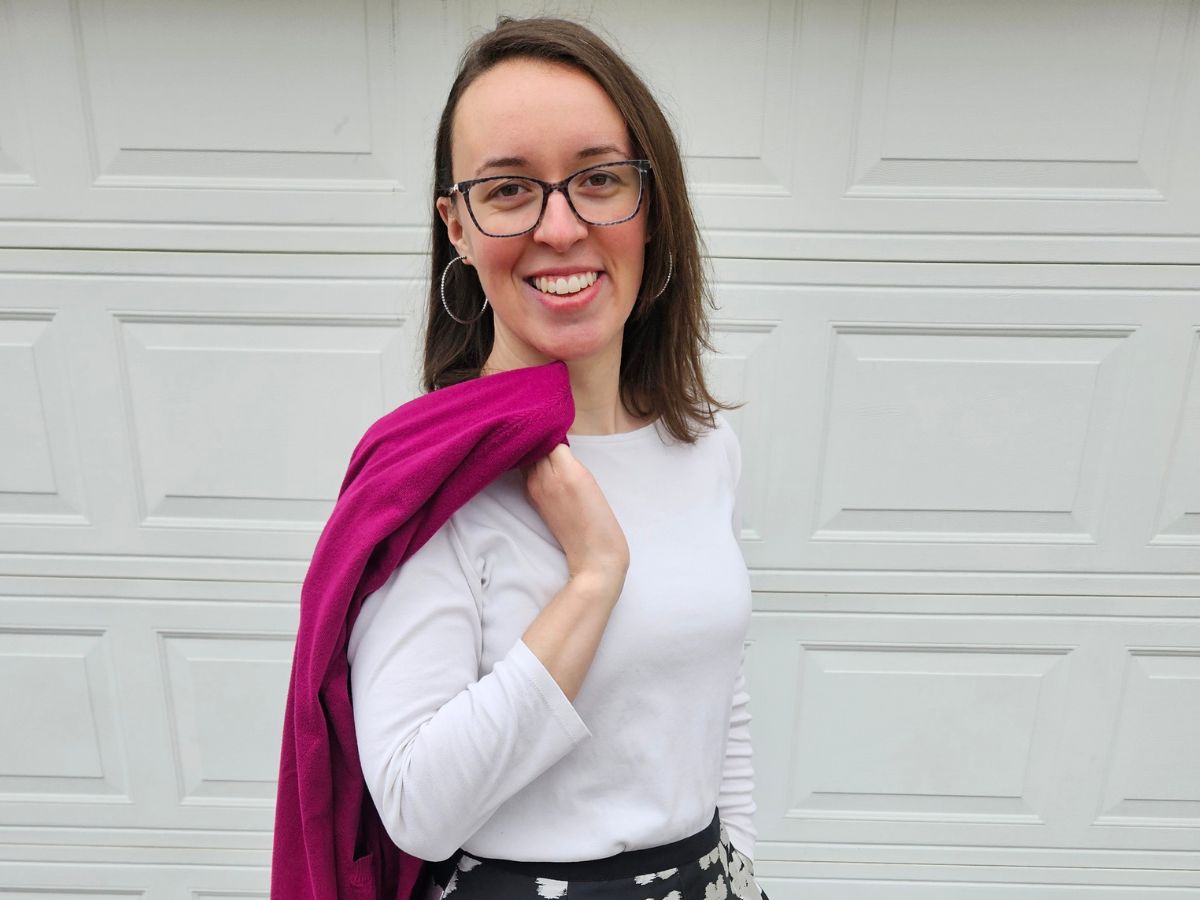 woman posing with gem colored cardigan