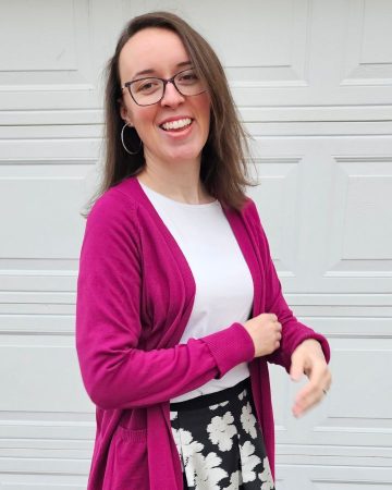 woman laughing in winter white and gem colored cardigan