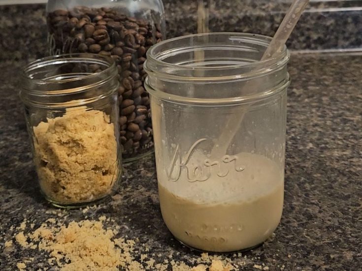 brown sugar latte with brown sugar and whole coffee beans in background