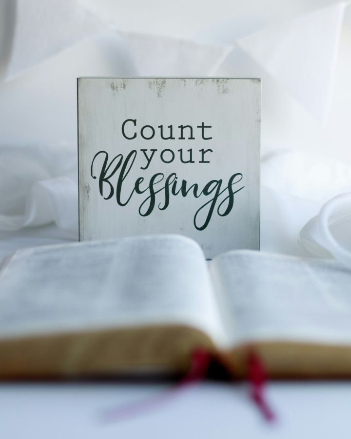count your blessings sign behind a bible