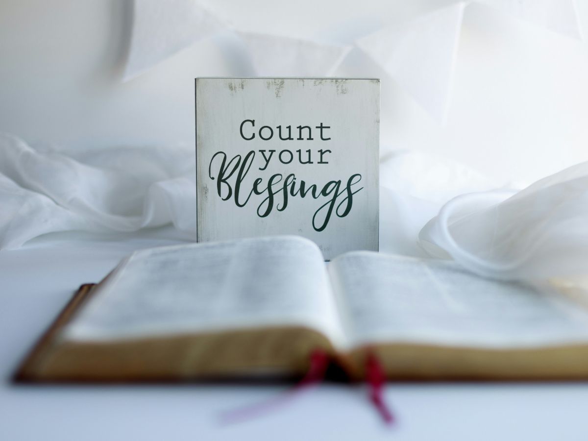 count your blessings sign behind a bible